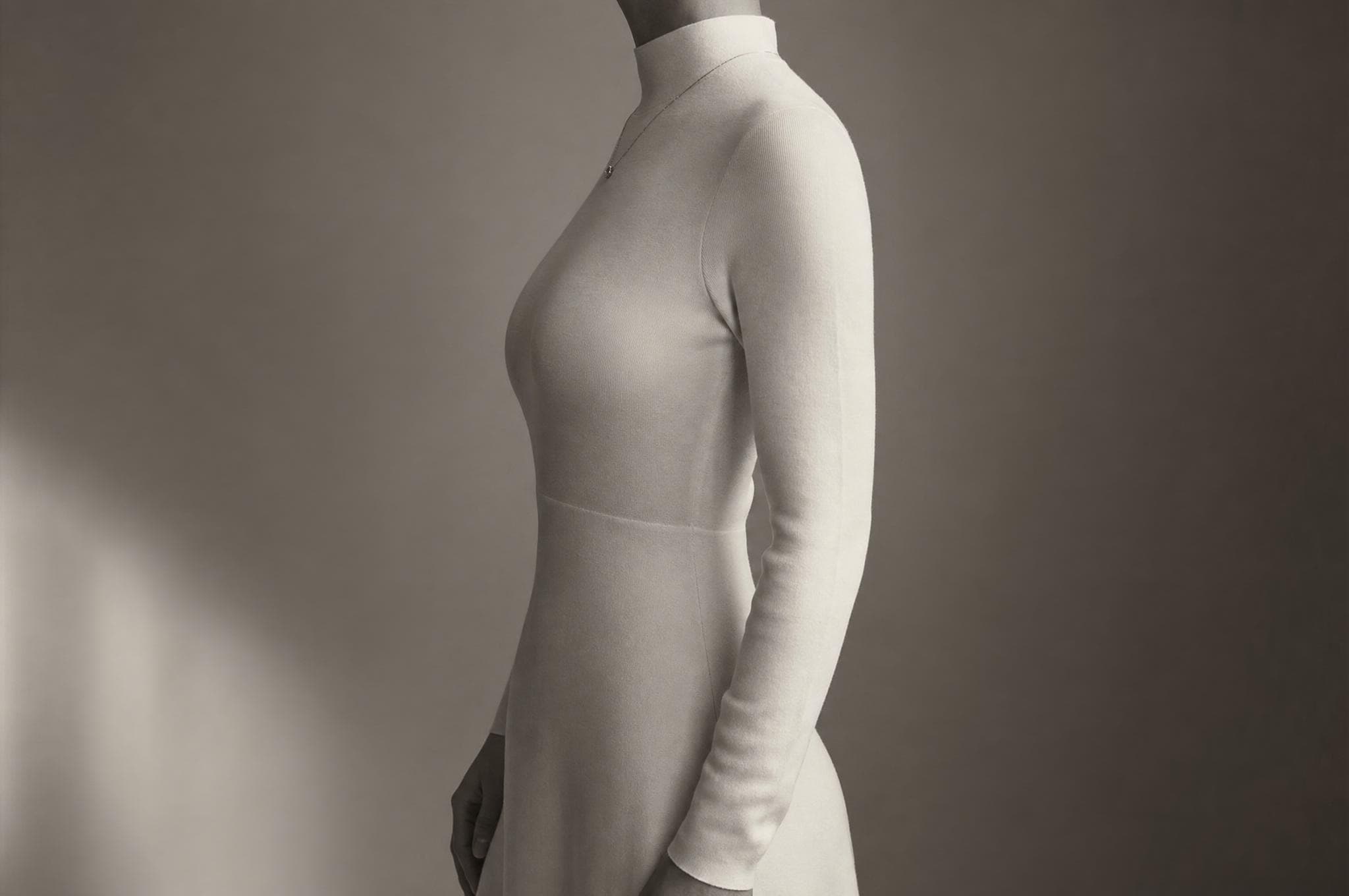 Collarbone and shoulder study beneath draped silk