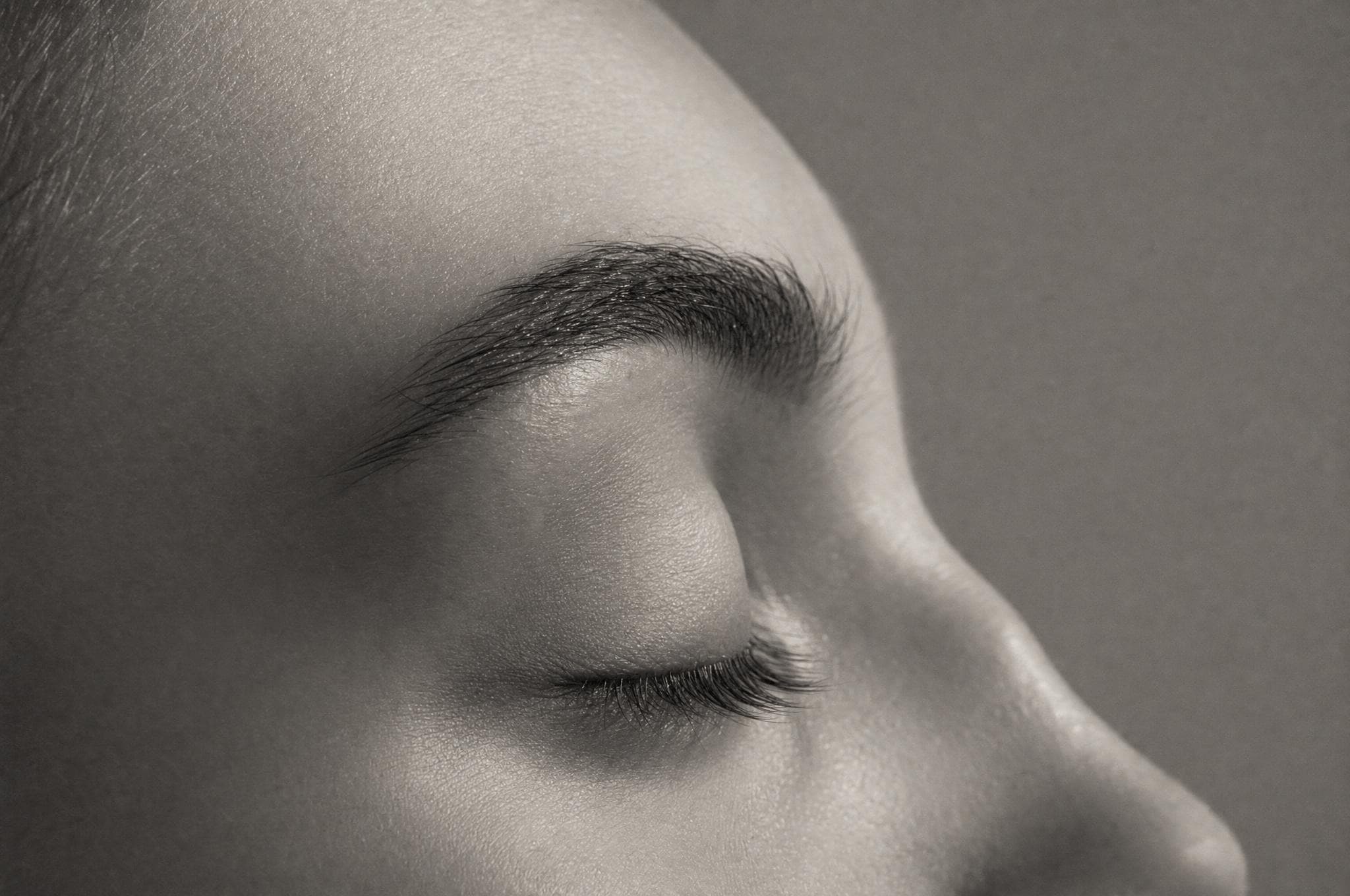 Soft-focus profile study of a closed eyelid and brow